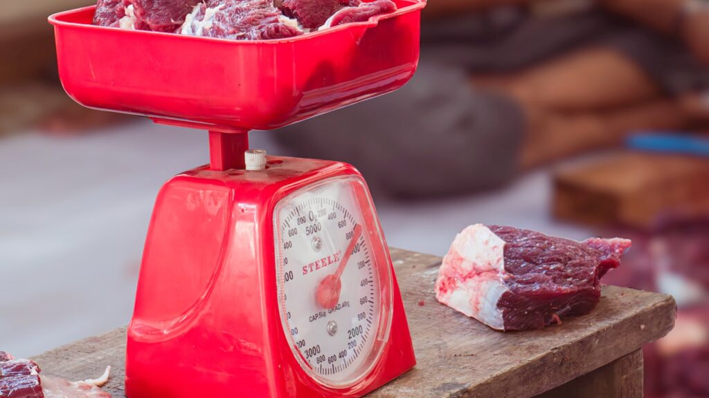 A butcher scale weighing meat for an online order