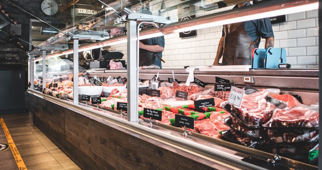 Butcher shop display counter with cuts of meat, the kind of store that takes repeat weekly orders