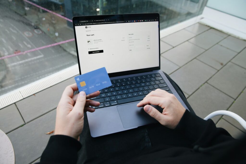 Customer holding a credit card while paying for an online order